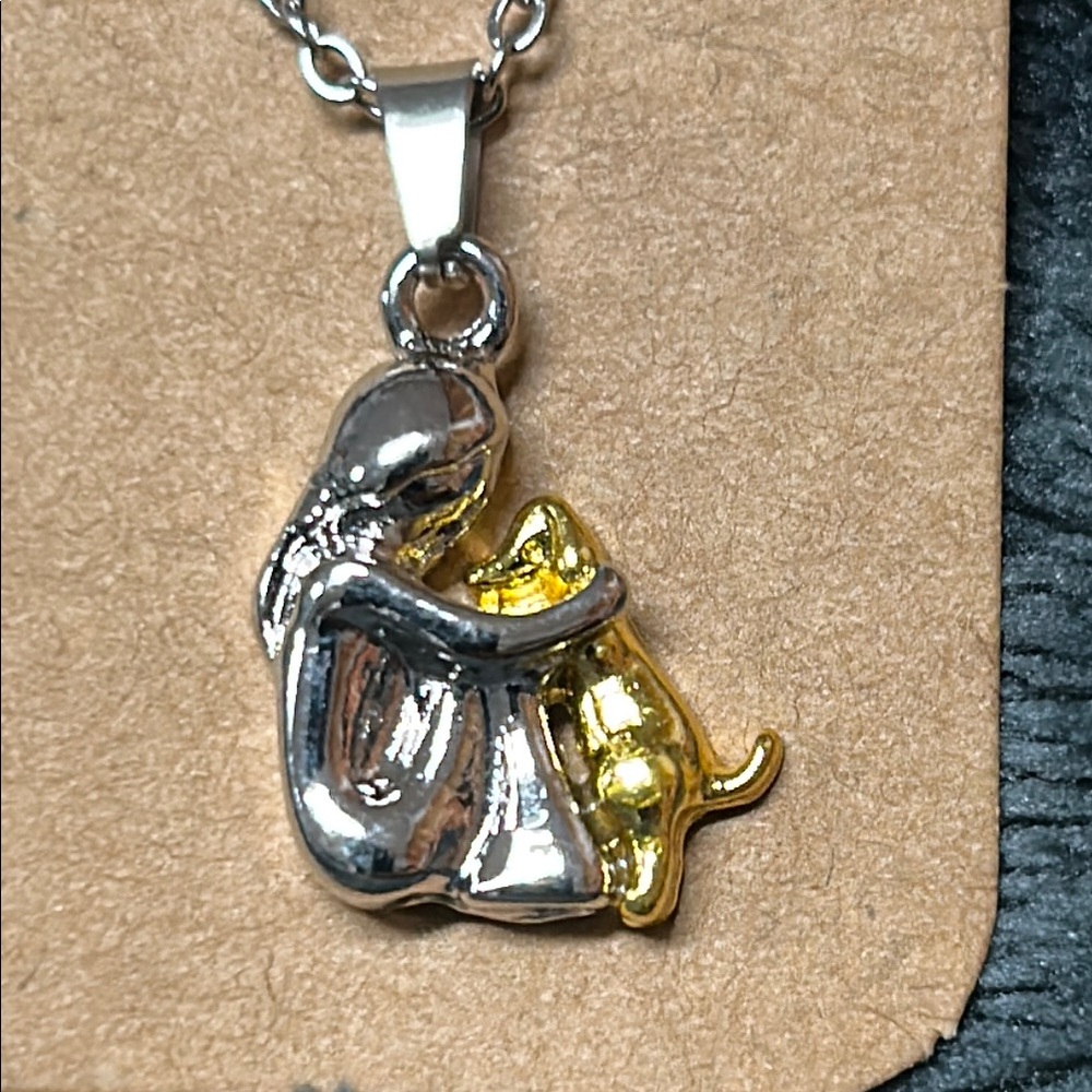 Silver and Gold Pendant with Girl and dog Design